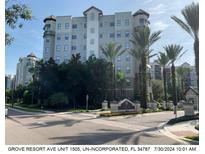 Modern high-rise building with palm trees and landscaping at 14501 Grove Resort Ave # 1505, Winter Garden, FL 34787