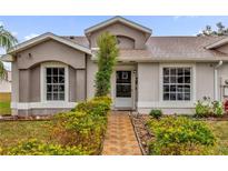 Exterior view of a charming house with well-manicured landscaping at 14657 Laguna Beach Cir, Orlando, FL 32824