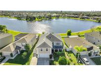 Two-story house with lake view and fenced backyard at 14962 Waterford Chase Pkwy, Orlando, FL 32828