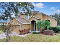 Two-story house with a two-car garage and landscaped front yard at 4364 Fox Glen Loop, Kissimmee, FL 34746