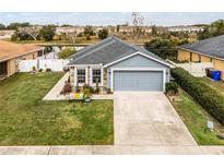Charming single-story home with a well-manicured lawn, two-car garage, and neutral blue tones at 540 E 19Th St, St Cloud, FL 34769