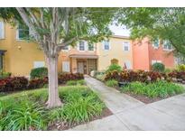 Front view of townhome with landscaping and walkway at 8407 Crystal Cove Cv, Kissimmee, FL 34747