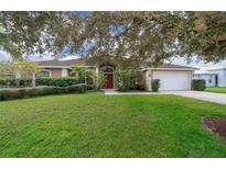 Single-story home with a large yard and mature trees at 11322 Bronson Rd, Clermont, FL 34711