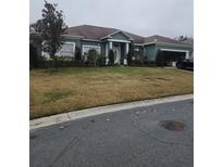 Single-story house with attached garage and well-maintained lawn at 2735 Berkford Cir, Lakeland, FL 33810