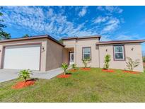 Charming single-story home with a well-manicured lawn and tidy landscaping at 9505 Luna Dr, St Cloud, FL 34773
