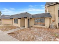 Tan house with gray roof, walkway, and small yard at 2223 Silver Pines Pl # 501, Orlando, FL 32808