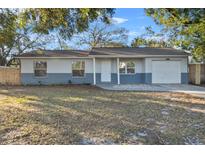 Newly renovated single-story home with gray and white exterior and a grassy yard at 3231 Avenue M Nw, Winter Haven, FL 33881