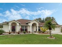 Single-story home with a well-manicured lawn and attractive landscaping at 4206 Sky Flower Ln, St Cloud, FL 34772