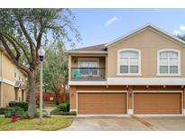 Townhome exterior with two car garage and landscaping at 525 Climbing Ivy Ct # A, Apopka, FL 32712