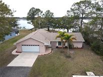 Aerial view of single-story home with lake access at 1186 Laguna Cir, St Cloud, FL 34771