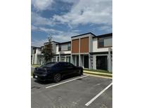 Modern townhome exterior with dark gray and brown accents at 3237 Energy Drive, Kissimmee, FL 34747