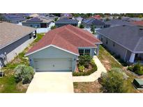 Charming single-Gathering home featuring a two-car garage and neatly landscaped front yard at 505 Pentas Ln, Haines City, FL 33844