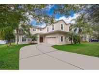 Two-story house with a large driveway and lush landscaping at 5454 Rishley Run Way, Mount Dora, FL 32757