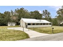 House with a metal roof, spacious yard, and detached shed at 616 Se 31St Ter, Ocala, FL 34471