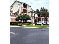 Apartment building exterior with landscaping and parking at 8296 Portofino Dr # 102, Davenport, FL 33896
