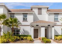 Two-story townhome with attractive landscaping and double-door entry at 8985 Stinger Dr, Davenport, FL 33896