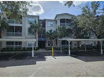 Exterior view of a condo building with parking at 3341 Whitestone Cir # 205, Kissimmee, FL 34741