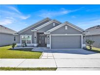 Charming single-story home with a well-manicured lawn and a two-car garage at 434 Panaro Ln, Haines City, FL 33844