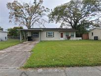 Charming single-story home with a well-maintained lawn and mature trees in a quiet neighborhood at 4824 Shoshone St, Orlando, FL 32819