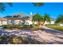 Beautiful one-story home with a large driveway and manicured landscaping at 5666 Merlin Way, St Cloud, FL 34772