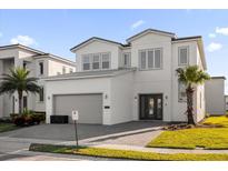 Two-story modern home with gray roof and attached garage at 2137 Pine Oak Loop, Davenport, FL 33837