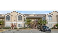 Two-story condo building with parking and landscaping at 2317 Prime Cir # B, Kissimmee, FL 34746