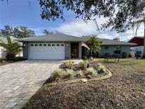 Single-story home with a paved driveway and landscaped front yard at 31 Augusta Cir, St Cloud, FL 34769