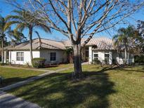 Single-story home with metal roof, landscaped lawn, and walkway at 3228 Abalone Blvd, Orlando, FL 32833