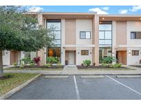 Modern townhome with sleek design and landscape at 7537 Brooklyn Dr, Kissimmee, FL 34747