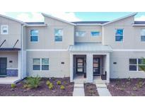 Two-story townhome with modern facade and landscaping at 1138 Kingsbarn St, Davenport, FL 33896
