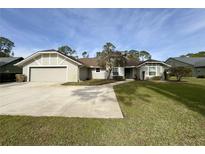 Single-story house with attached garage and a spacious driveway at 2260 Spring Lake Cir, St Cloud, FL 34771