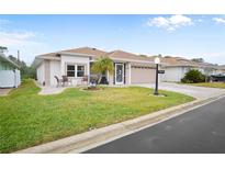 Front view of a single-story house with a paved driveway at 580 Teesdale, Haines City, FL 33844