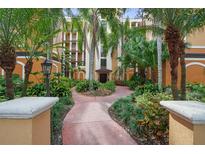 Landscaped courtyard entrance to the building at 12538 Floridays Resort Dr # 411, Orlando, FL 32821