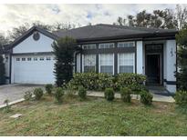 Exterior shot of house showing garage and front entry at 143 Glasgow Ct, Davenport, FL 33897