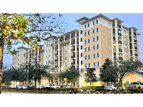 Luxury condo building boasts an appealing facade and beautifully manicured landscaping at 8100 Poinciana Blvd # 2405, Orlando, FL 32821