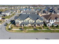 Aerial view of a charming townhome community with a lake at 2455 Varenna Loop # 1, Kissimmee, FL 34741