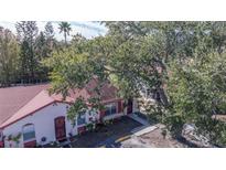 Cozy single-story villa with red trim, mature landscaping, and designated parking at 46 W Marbrisa Way, Kissimmee, FL 34743