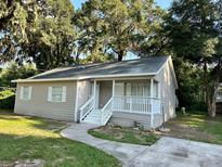 Tan house with white trim, steps, and a walkway at 5920 Nw 65Th St, Ocala, FL 34482