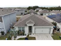Aerial view of a house and surrounding neighborhood at 606 Tortugas St, Haines City, FL 33844