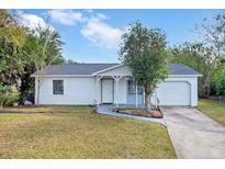 White single-story house with gray roof, attached garage, and well-manicured lawn at 110 Talavera Ln, Kissimmee, FL 34758