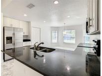 Modern kitchen featuring stainless steel appliances, sleek countertops, and ample cabinet space at 438 Jay Ct, Kissimmee, FL 34759