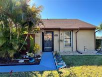 Inviting exterior with landscaped walkway and tropical plants at 812 Park Villa Cir, Orlando, FL 32824