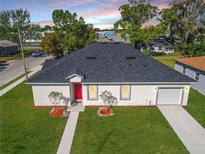 Beautiful single Gathering home featuring a new roof, a well manicured lawn, and an attached garage at 1022 Mack Ave, Orlando, FL 32805