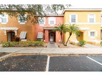 Front view of a three-unit townhome building with parking at 1118 Park Ridge Cir, Kissimmee, FL 34746