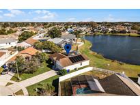 Aerial view of a single-Gathering home with a pool and lake access at 2302 Aberdeen Ct, Kissimmee, FL 34743