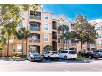 Three-story condo building with ample parking and landscaping at 2774 Almaton Loop # 305, Kissimmee, FL 34747