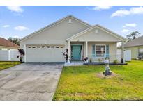 Charming house with a two-car garage and landscaped front yard at 4702 Ashurst St, Kissimmee, FL 34758