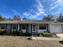 Ranch style home with a carport and well-maintained lawn at 5319 Glasgow Ave, Orlando, FL 32819