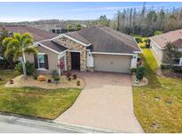 Aerial view of single-story house with solar panels and landscaped yard at 672 San Joaquin Rd, Kissimmee, FL 34759