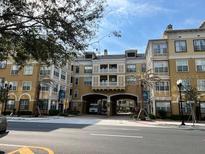 Elegant condo building with attractive facade and landscaping at 860 N Orange Ave # 471, Orlando, FL 32801